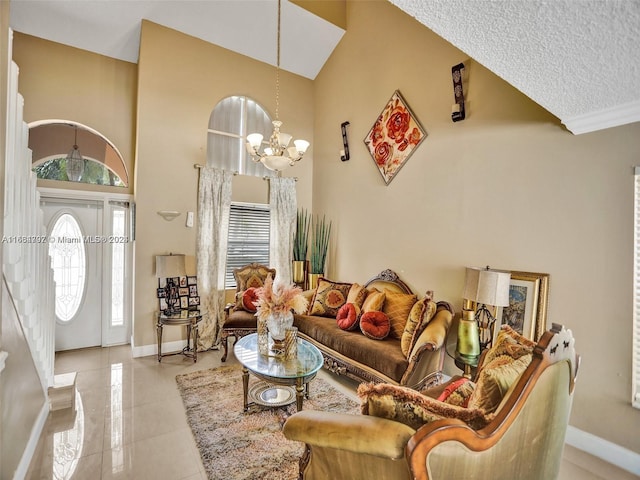 living room featuring a high ceiling, a chandelier, a textured ceiling, and plenty of natural light