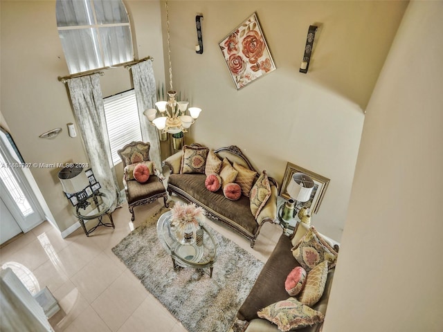 tiled living room featuring an inviting chandelier and a wealth of natural light