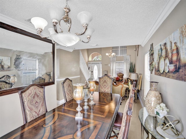 dining room with ornamental molding, a textured ceiling, and an inviting chandelier