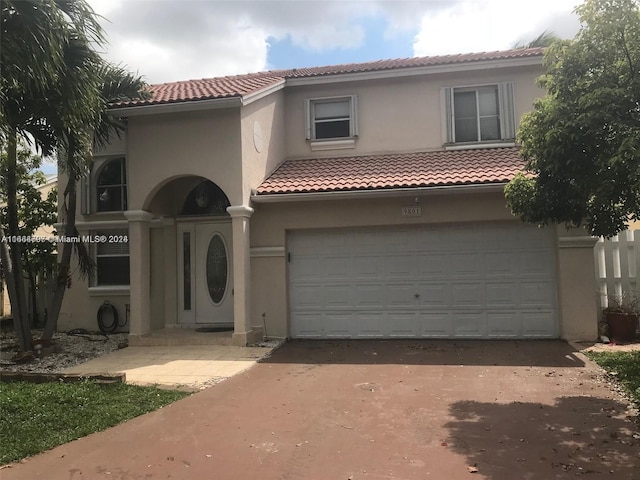 mediterranean / spanish house featuring a garage