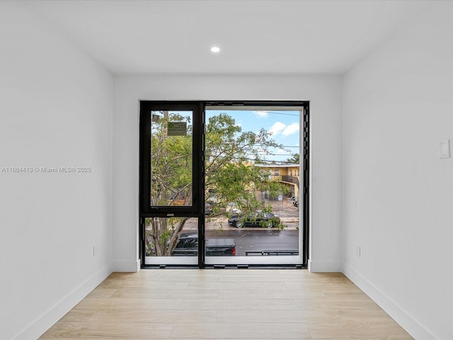 entryway featuring recessed lighting, baseboards, and wood finished floors