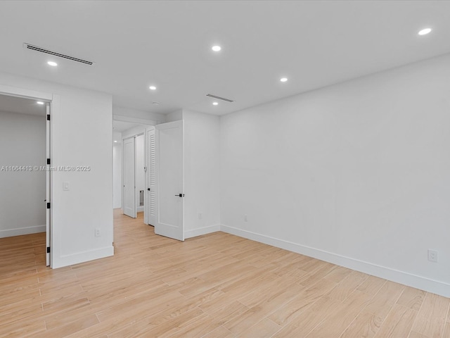 unfurnished room featuring light wood-style flooring, visible vents, and recessed lighting