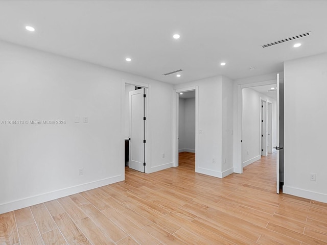 unfurnished room with baseboards, recessed lighting, visible vents, and light wood-style floors