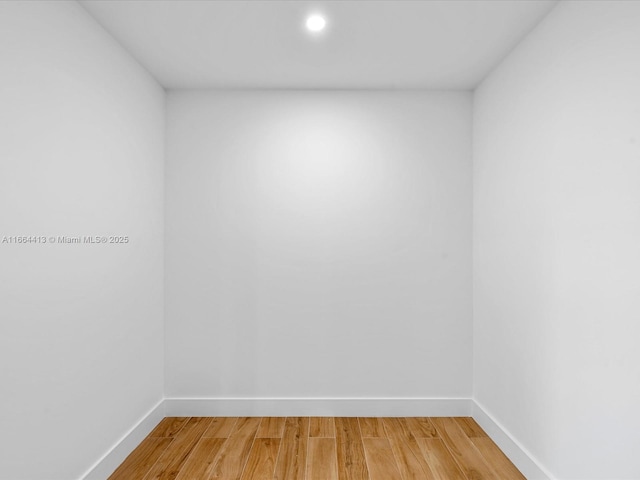 empty room with light wood-style flooring and baseboards