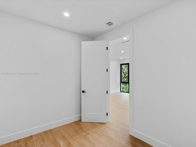 empty room featuring baseboards, recessed lighting, visible vents, and light wood-style floors