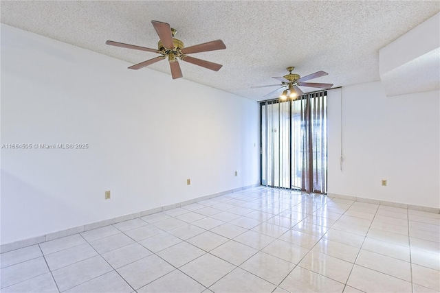 unfurnished room featuring light tile patterned flooring, ceiling fan, and a textured ceiling