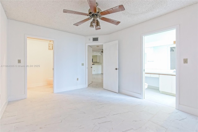 unfurnished bedroom with ceiling fan, a textured ceiling, and ensuite bathroom