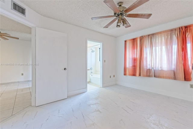 unfurnished bedroom featuring ceiling fan, connected bathroom, and a textured ceiling