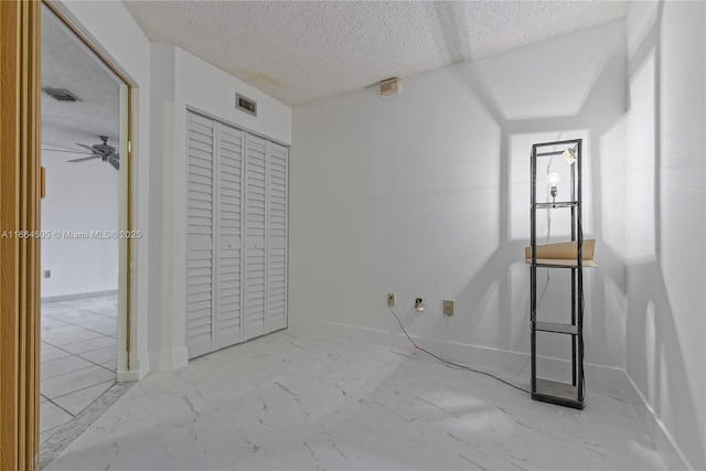 unfurnished bedroom with a textured ceiling and a closet