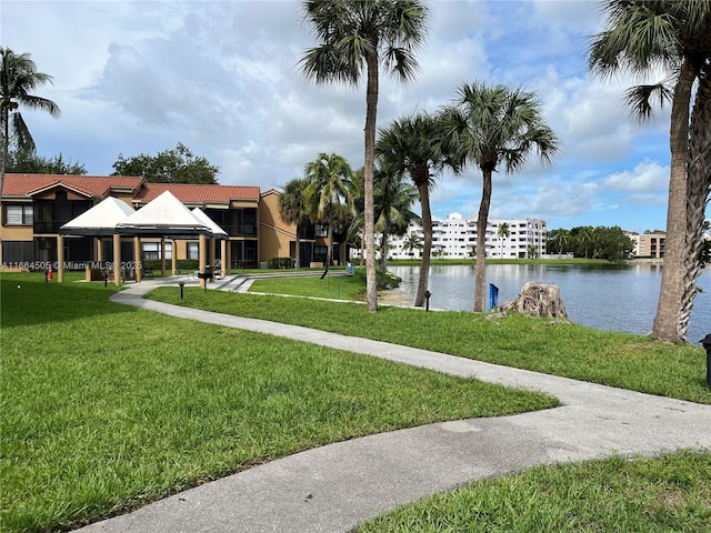 exterior space with a water view, a gazebo, and a lawn