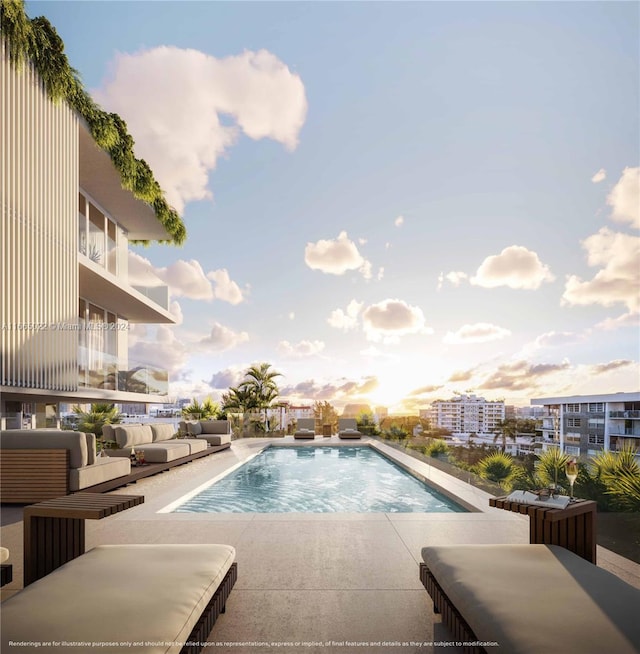 pool at dusk featuring an outdoor living space and a patio area