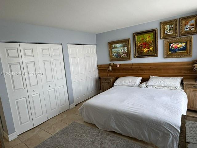 tiled bedroom with two closets