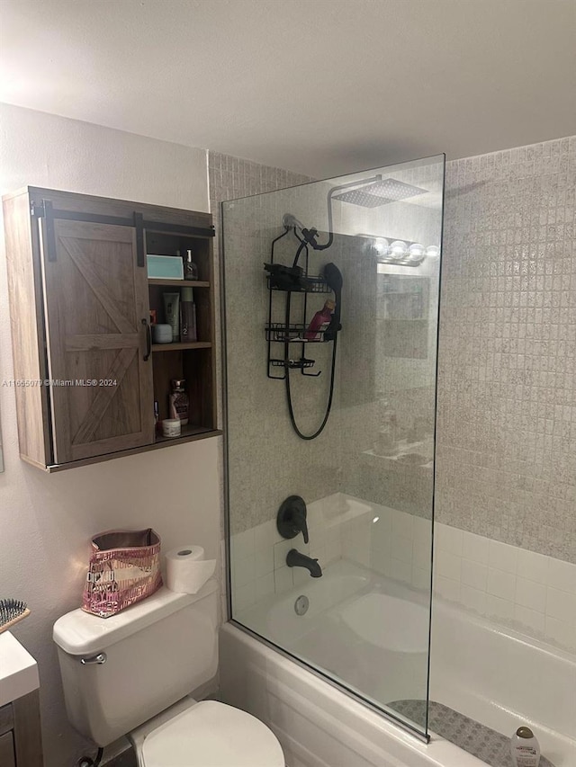 full bathroom featuring shower / bath combination with glass door, vanity, and toilet