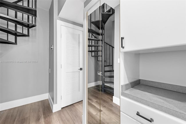 staircase with hardwood / wood-style floors