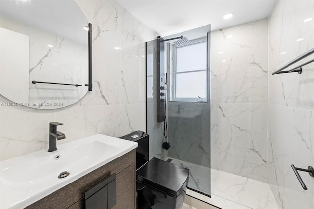 bathroom featuring tiled shower, vanity, and tile walls