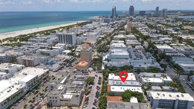 drone / aerial view featuring a water view and a beach view