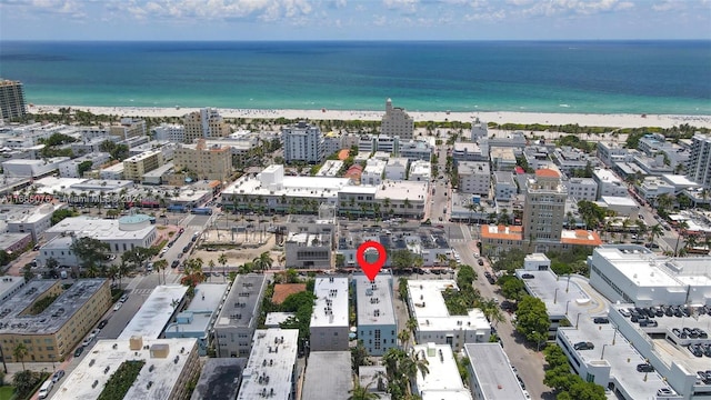 bird's eye view featuring a water view and a view of the beach