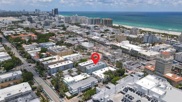 aerial view with a water view and a beach view