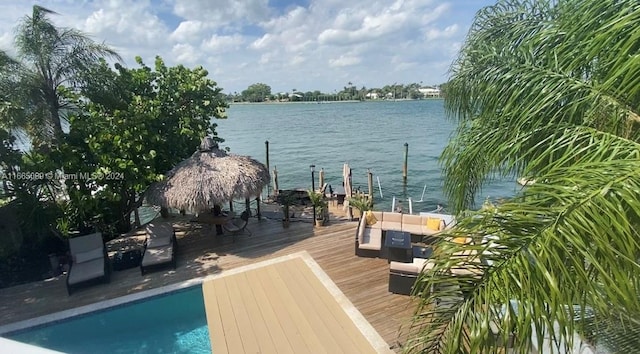 exterior space featuring a swimming pool side deck with water view