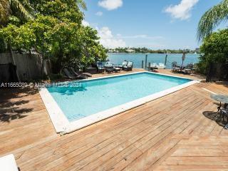 view of pool featuring a deck with water view