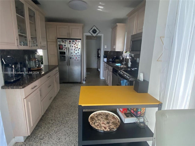 kitchen featuring appliances with stainless steel finishes, sink, and decorative backsplash