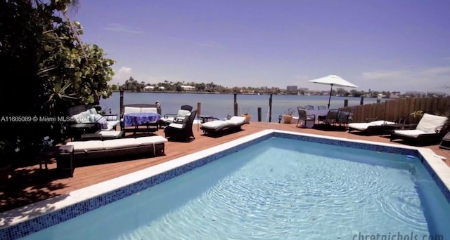 view of pool featuring a water view