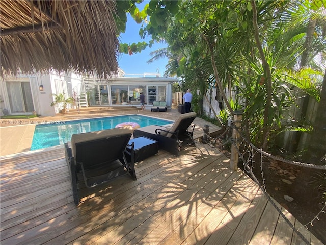 view of swimming pool with a deck