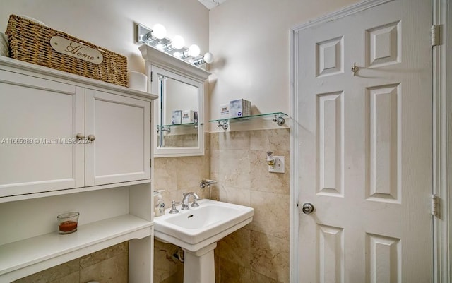 bathroom with tile walls and sink