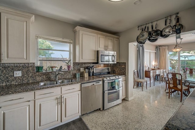 kitchen with decorative backsplash, appliances with stainless steel finishes, plenty of natural light, and sink