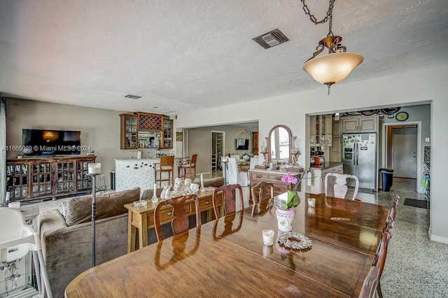 dining area with a textured ceiling