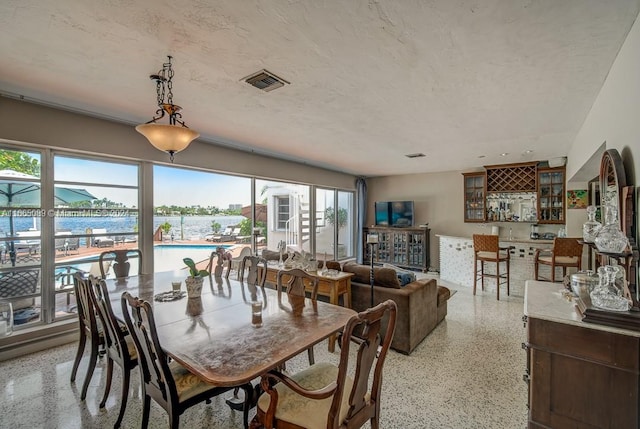 dining area featuring a textured ceiling