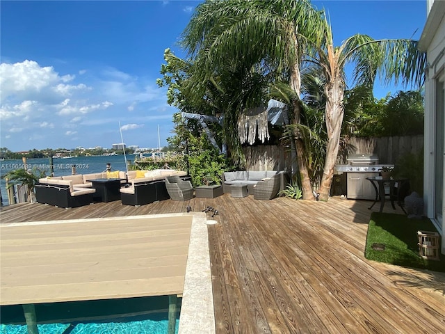 wooden deck with a water view and an outdoor hangout area