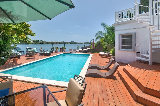 view of swimming pool featuring a deck with water view