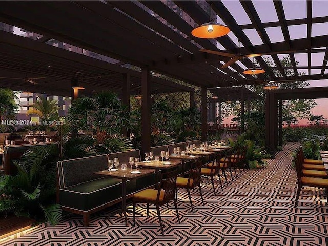 patio terrace at dusk with a pergola and ceiling fan