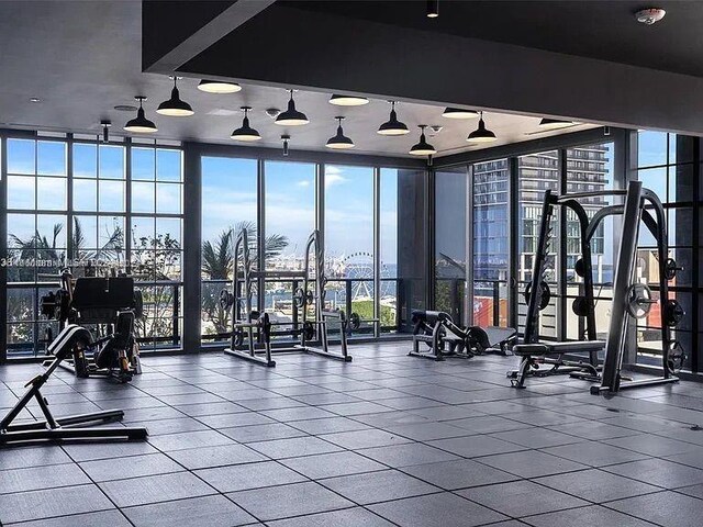 gym featuring floor to ceiling windows and plenty of natural light