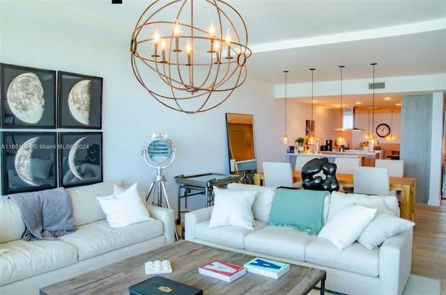 living room featuring a notable chandelier and wood-type flooring