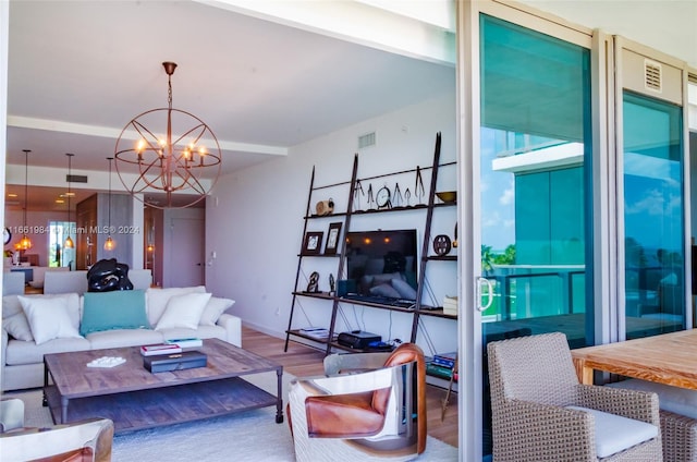 living room featuring an inviting chandelier and hardwood / wood-style flooring