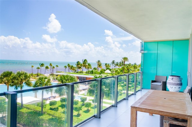 balcony featuring a water view and a view of the beach