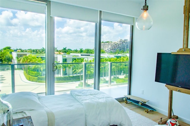 bedroom featuring multiple windows and hardwood / wood-style floors