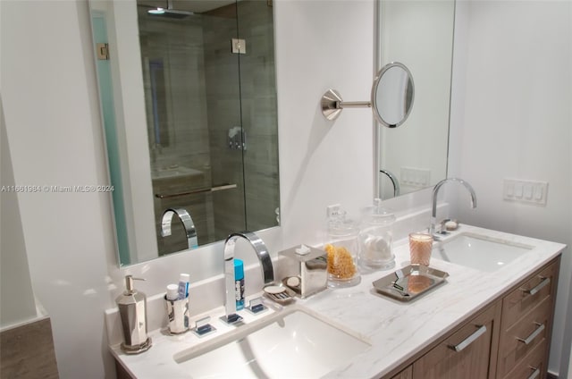 bathroom featuring vanity and a shower with door