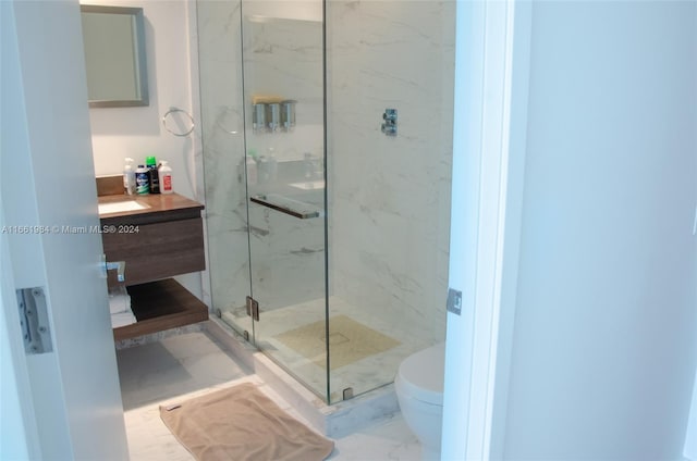 bathroom with walk in shower, vanity, and toilet