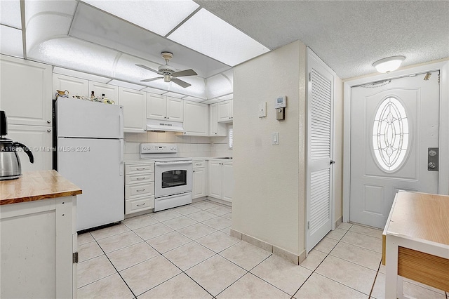 kitchen with ceiling fan, white cabinets, light tile patterned floors, wooden counters, and white appliances