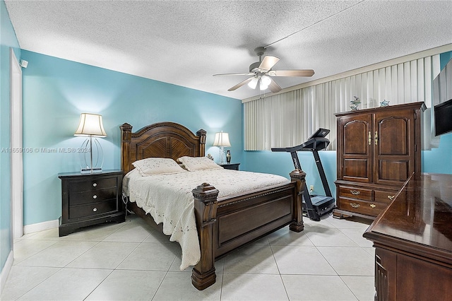 bedroom with a textured ceiling, light tile patterned flooring, and ceiling fan