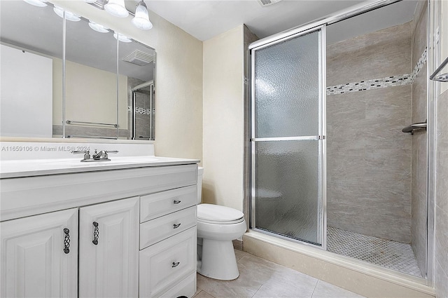 bathroom featuring tile patterned floors, an enclosed shower, vanity, and toilet