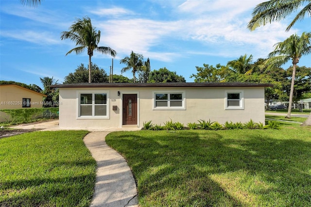 ranch-style house with a front lawn