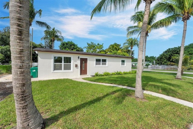 ranch-style house featuring a front lawn