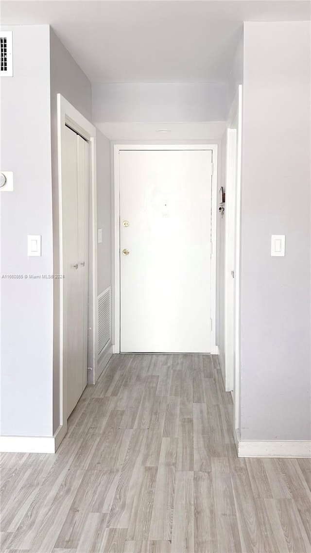 corridor featuring light hardwood / wood-style flooring