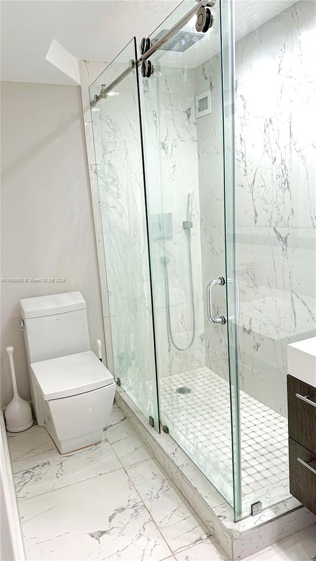 bathroom featuring vanity, toilet, and an enclosed shower