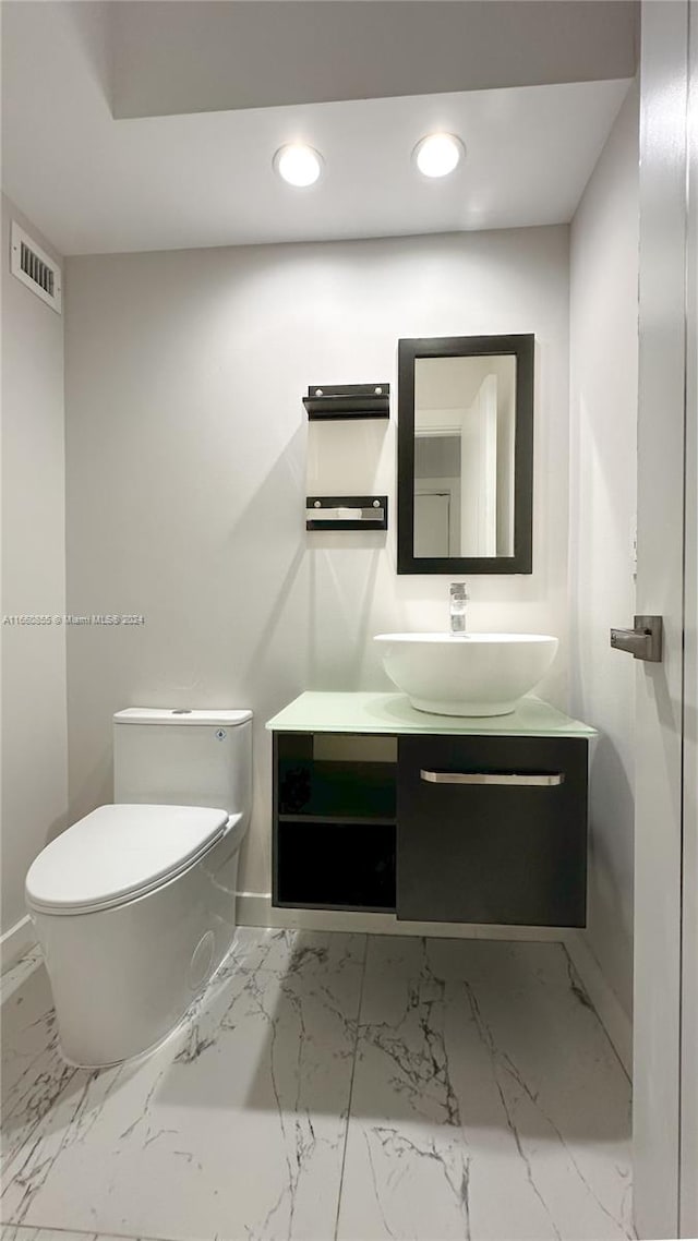 bathroom featuring vanity and toilet