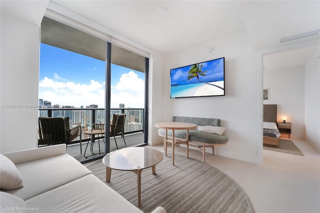 living room with visible vents and a wall of windows